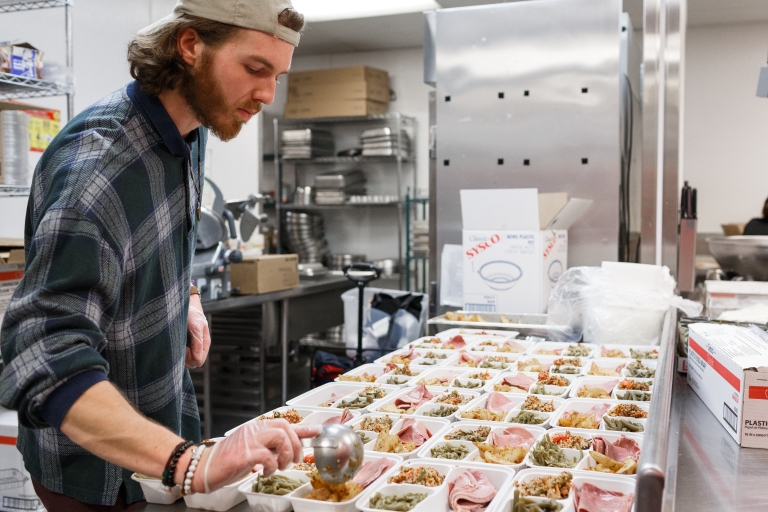 Senior Dylan Patterson prepares meals for the new Paws' Express program in the Campus Center kitchen. Photo by Liz Kaye, Indiana University